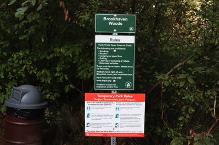 Signage at trailhead on park rules includes Dawn to Dusk hours and phone numbers
